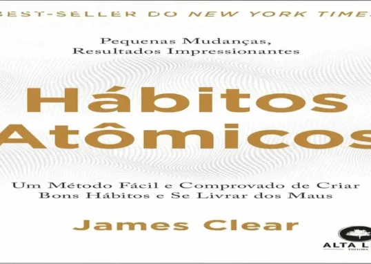Livro físico Hábitos Atômicos de James Clear aberto mostrando diagramas internos